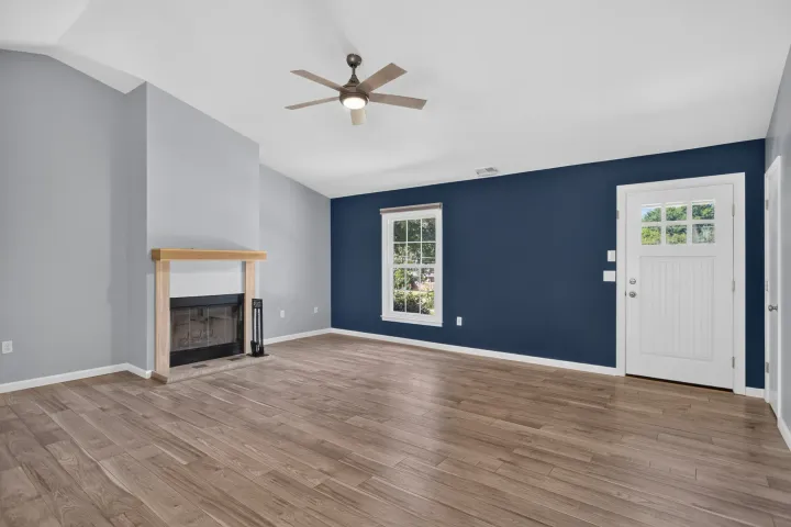 Living room with cathedral ceiling and fireplace